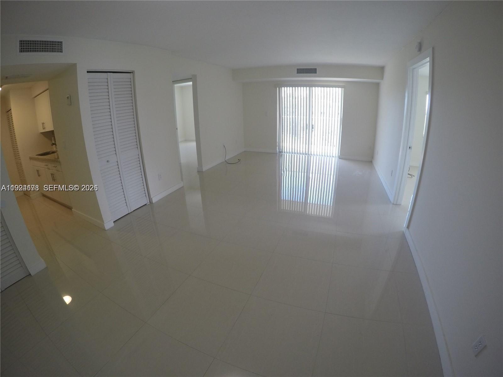 8200 Southwest 210th Street, Unit 320 Cutler Bay, FL 33189 - Photo 5 of 14 an empty room with windows and closet