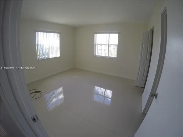 a view of an empty room and window