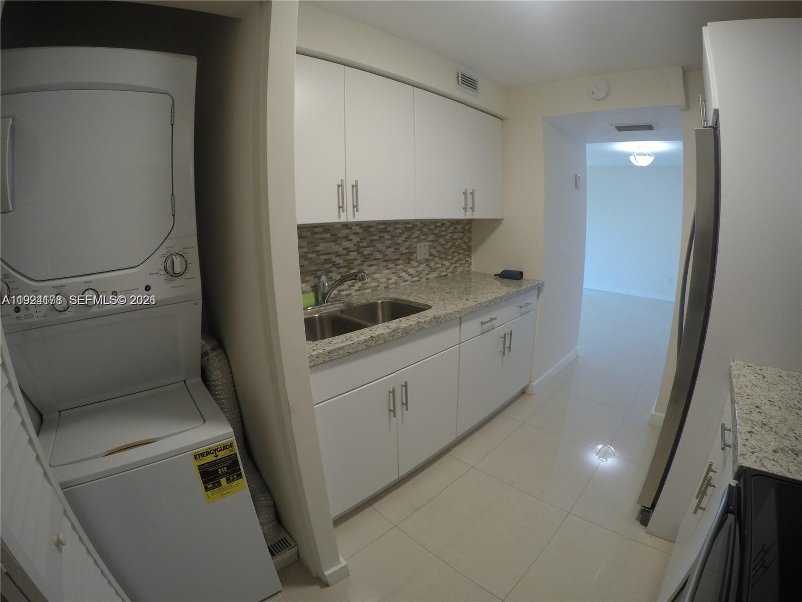 8200 Southwest 210th Street, Unit 320 Cutler Bay, FL 33189 - Photo 7 of 14 a utility room with dryer and washer