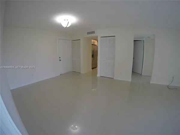 an empty room with closet and wooden floor