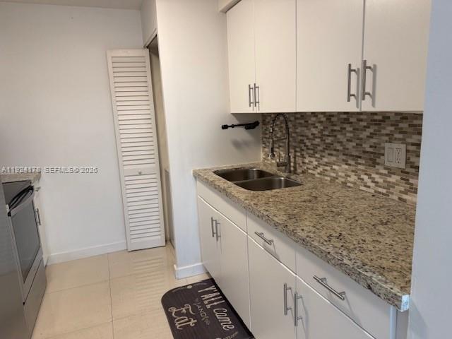 8200 Southwest 210th Street, Unit 320 Cutler Bay, FL 33189 - Photo 8 of 14 a kitchen with granite countertop white cabinets and a sink