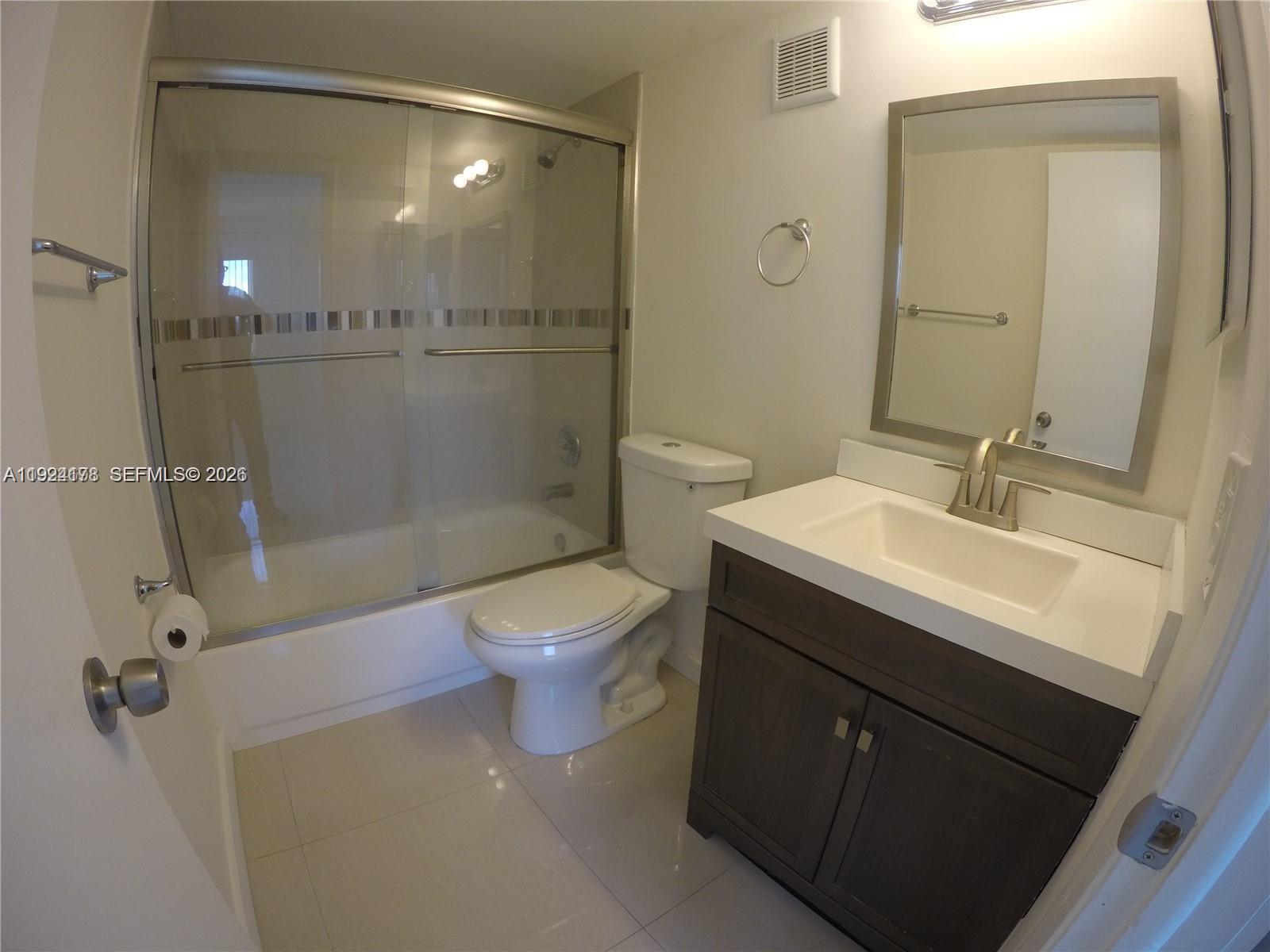 8200 Southwest 210th Street, Unit 320 Cutler Bay, FL 33189 - Photo 9 of 14 a bathroom with a sink mirror toilet and shower