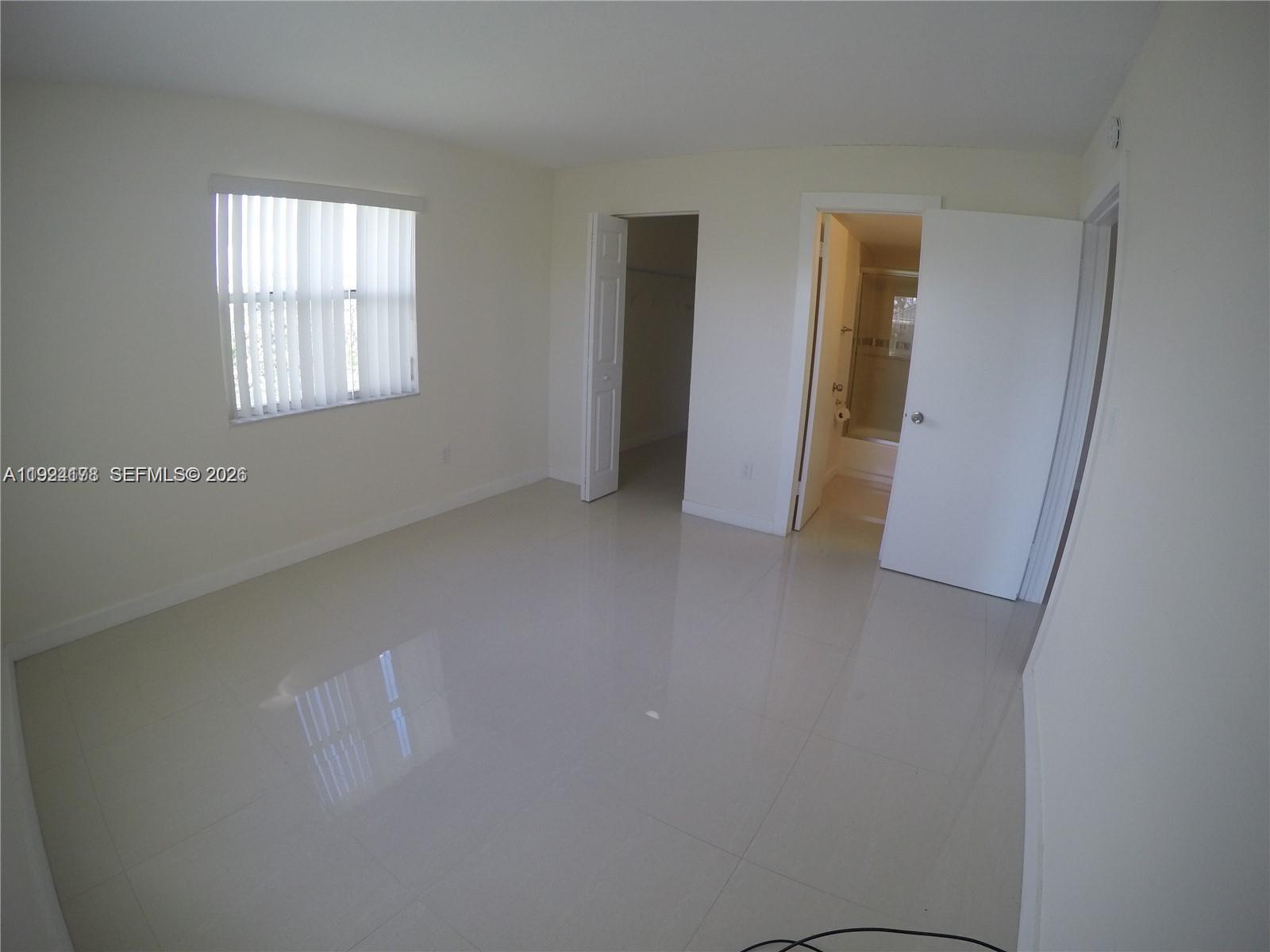 8200 Southwest 210th Street, Unit 320 Cutler Bay, FL 33189 - Photo 10 of 14 an empty room with windows and closet