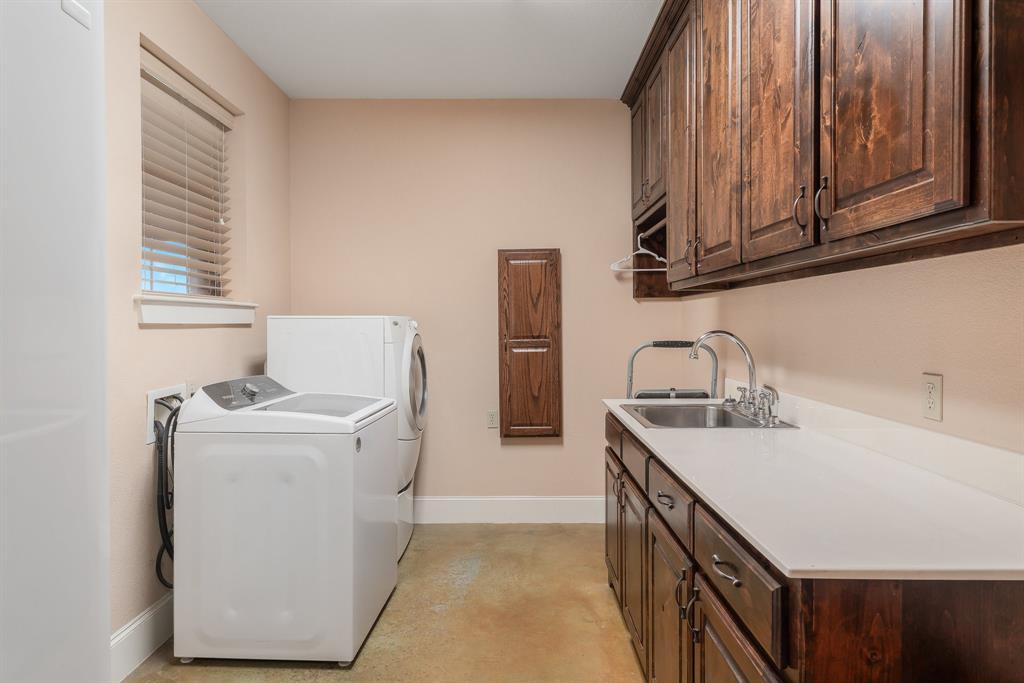 289 Blackjack Road Valley View, TX 76272 - Photo 17 of 40 a kitchen with stainless steel appliances granite countertop a sink stove and refrigerator