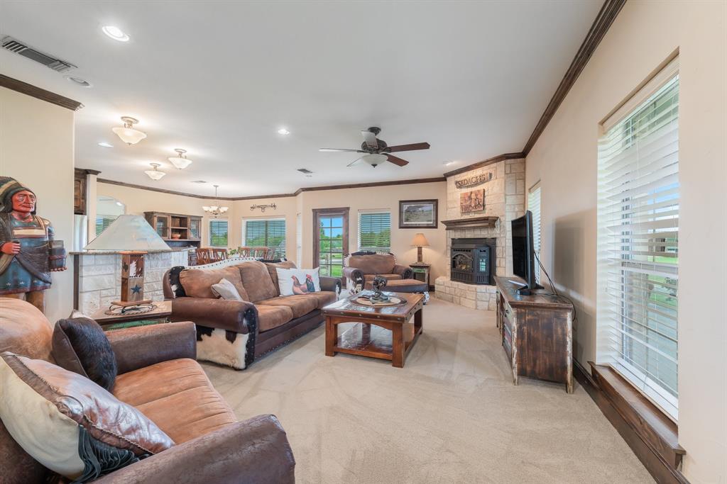 289 Blackjack Road Valley View, TX 76272 - Photo 19 of 40 a living room with furniture a flat screen tv and a fireplace