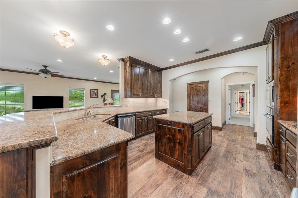 289 Blackjack Road Valley View, TX 76272 - Photo 22 of 40 a kitchen with stainless steel appliances granite countertop a stove and a refrigerator