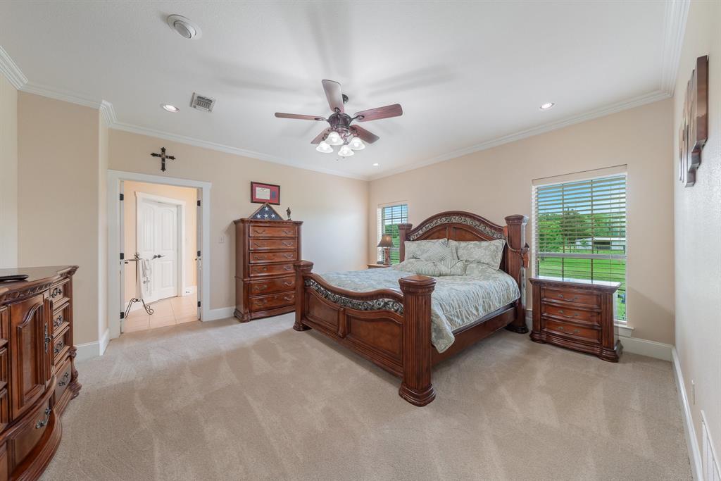 289 Blackjack Road Valley View, TX 76272 - Photo 26 of 40 a spacious bedroom with a bed and a chandelier