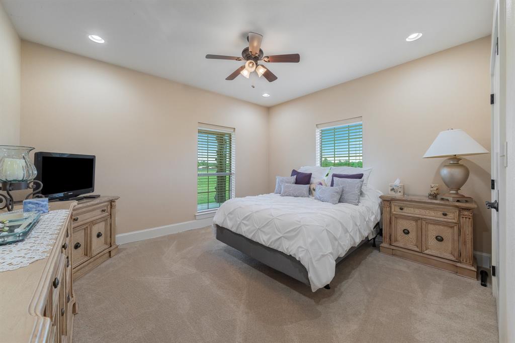 289 Blackjack Road Valley View, TX 76272 - Photo 31 of 40 a spacious bedroom with a bed and a chandelier