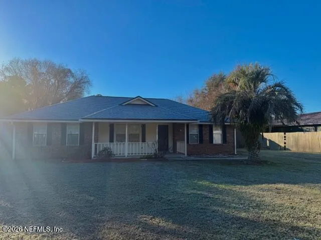 a view of house with a yard