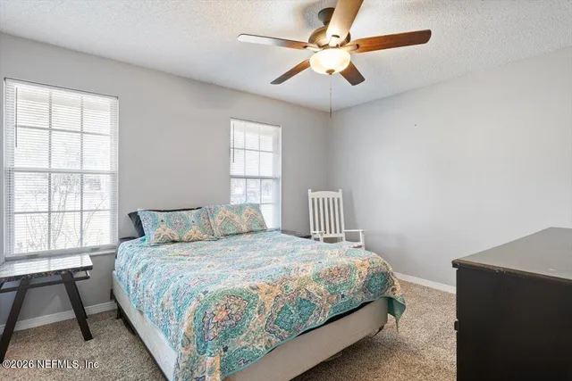 a large kitchen with a large window and stainless steel appliances