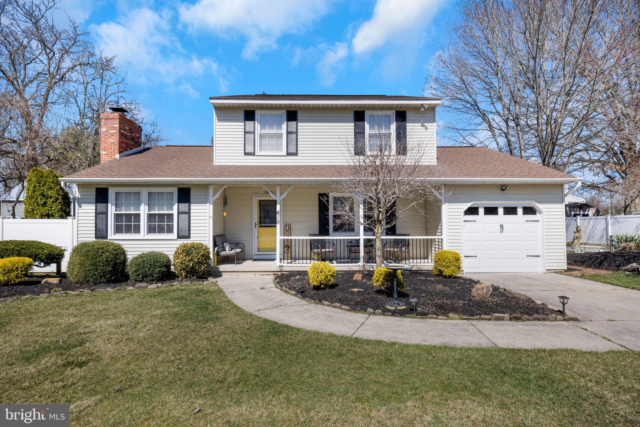 a front view of a house with garden and porch