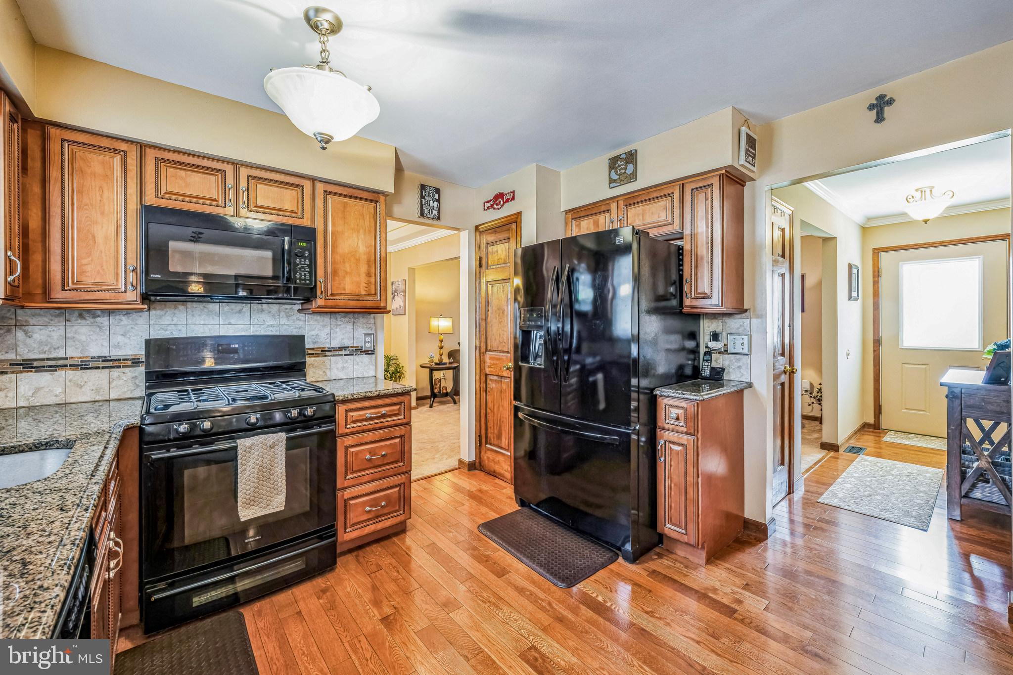 415 Doerrmann Drive Mickleton, NJ 08056 - Photo 17 of 38 a kitchen with stainless steel appliances a stove a refrigerator and a sink