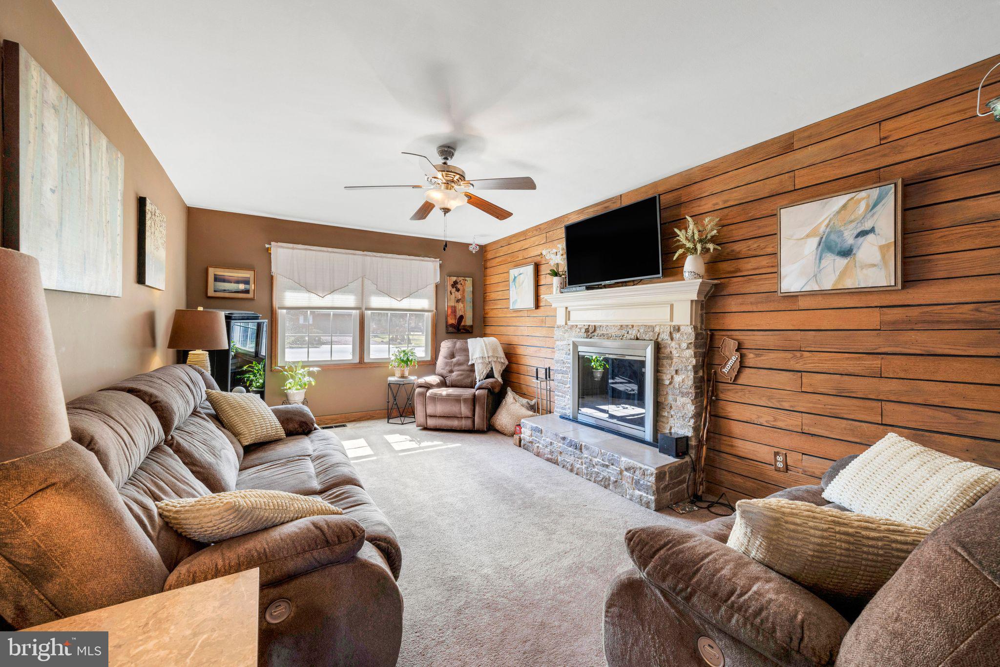 415 Doerrmann Drive Mickleton, NJ 08056 - Photo 18 of 38 a living room with furniture a fireplace and a flat screen tv