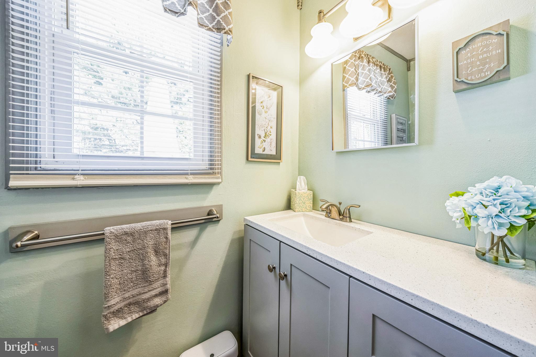 415 Doerrmann Drive Mickleton, NJ 08056 - Photo 21 of 38 a bathroom with a sink mirror and a window