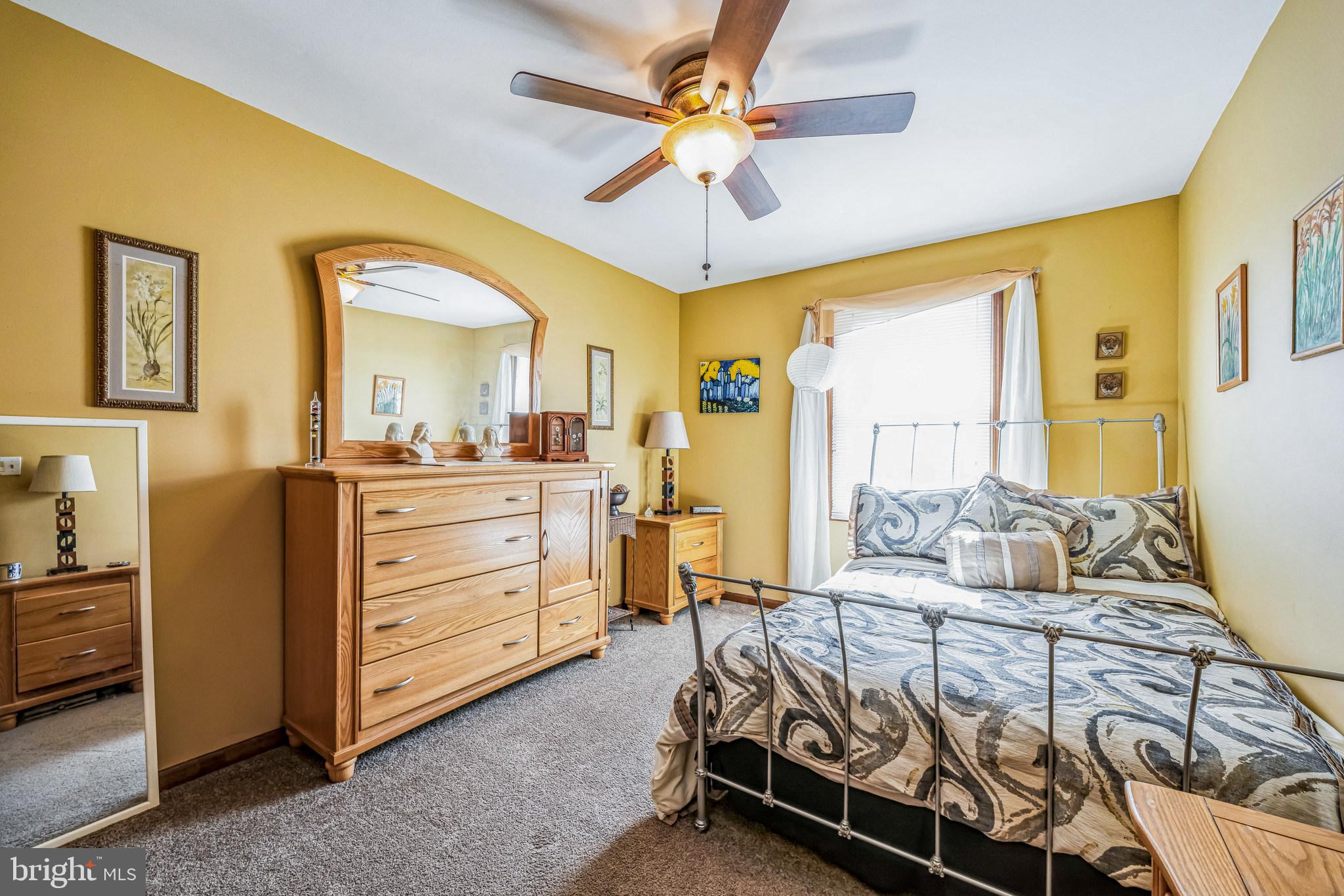 415 Doerrmann Drive Mickleton, NJ 08056 - Photo 23 of 38 a bedroom with a bed and a chandelier