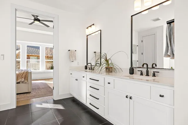 a bathroom with a double vanity sink mirror and