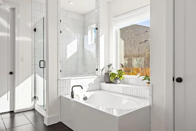 a bathroom with a tub sink and mirror