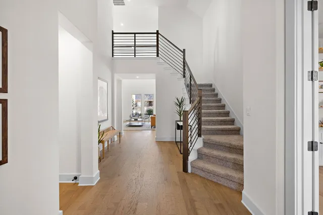 a view of entryway and hall with wooden floor