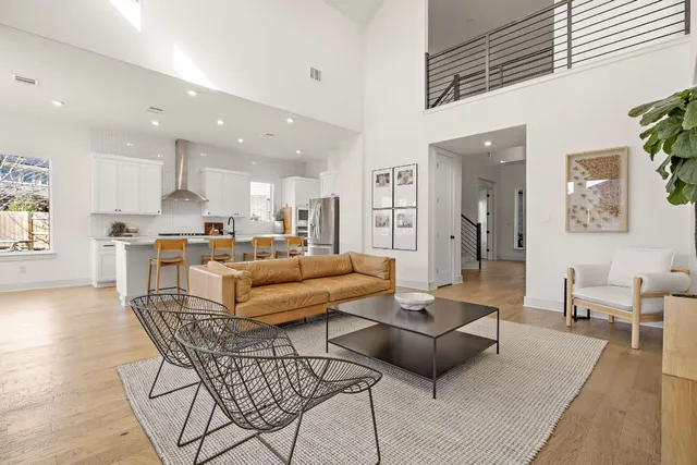 a living room with furniture and kitchen view