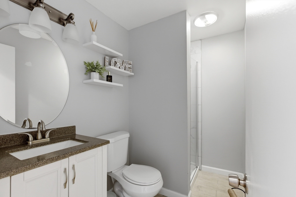 57 Carriage House Path Ashland, MA 01721 - Photo 13 of 37 a bathroom with a granite countertop sink mirror vanity and toilet