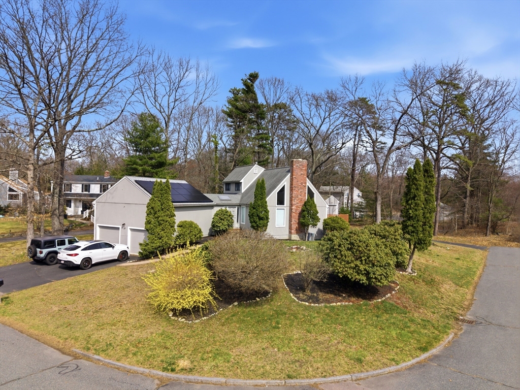57 Carriage House Path Ashland, MA 01721 - Photo 22 of 37 a view of a white house with a yard patio and fire pit