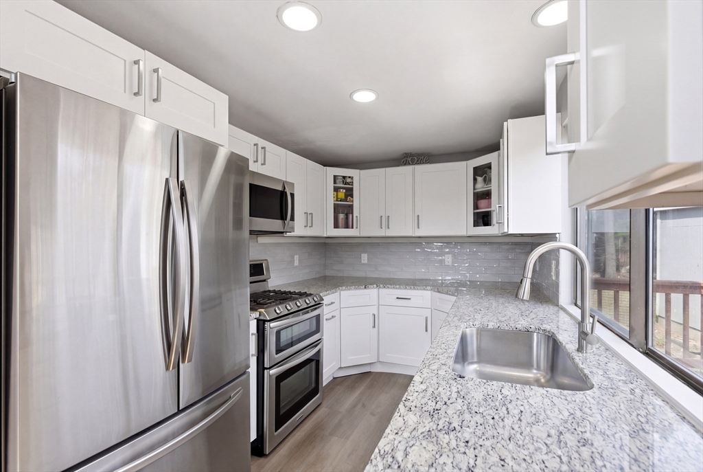 57 Carriage House Path Ashland, MA 01721 - Photo 5 of 37 a kitchen with stainless steel appliances granite countertop a refrigerator a stove top oven a sink and dishwasher