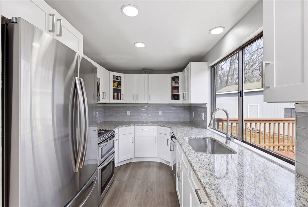 57 Carriage House Path Ashland, MA 01721 - Photo 6 of 37 a kitchen with a refrigerator sink and cabinets