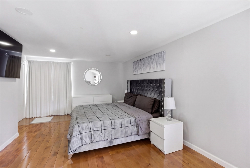 57 Carriage House Path Ashland, MA 01721 - Photo 10 of 37 a bedroom with a bed and a night stand
