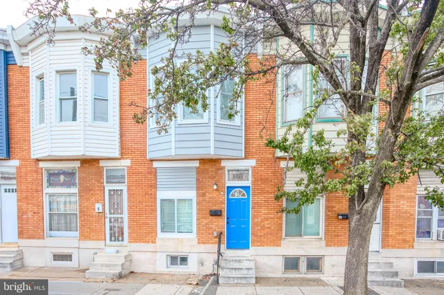 a front view of a residential apartment building with a yard
