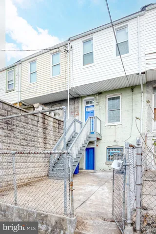 a view of a patio with a table and chairs