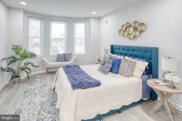 a bedroom with a bed and a couch