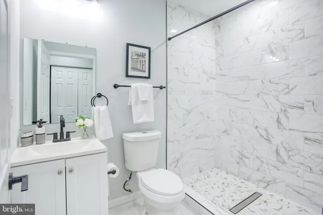 a white toilet sitting next to a bathroom sink