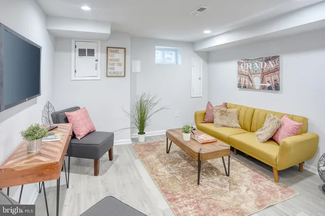 a living room with furniture and a potted plant