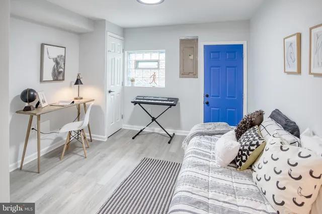 a bedroom with a bed a table and chair