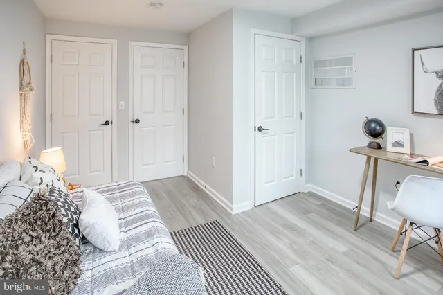 a bedroom with a bed and a chair in it