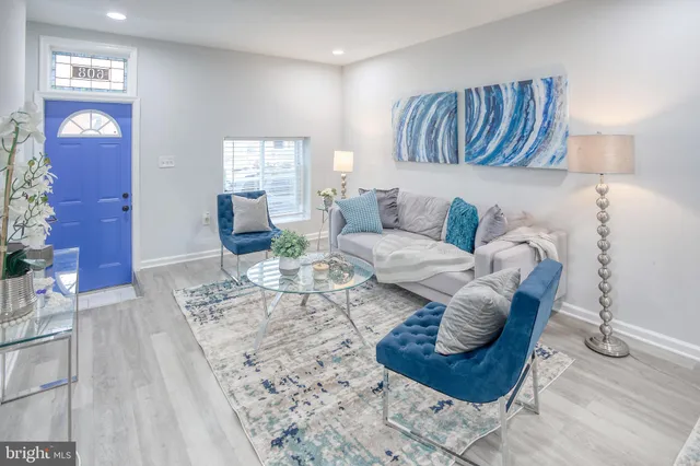 a living room with furniture or couch and a potted plant