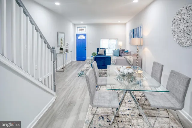 a view of a dining room with furniture and wooden floor