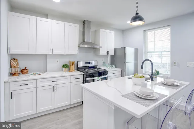 a kitchen with white cabinets and white appliances