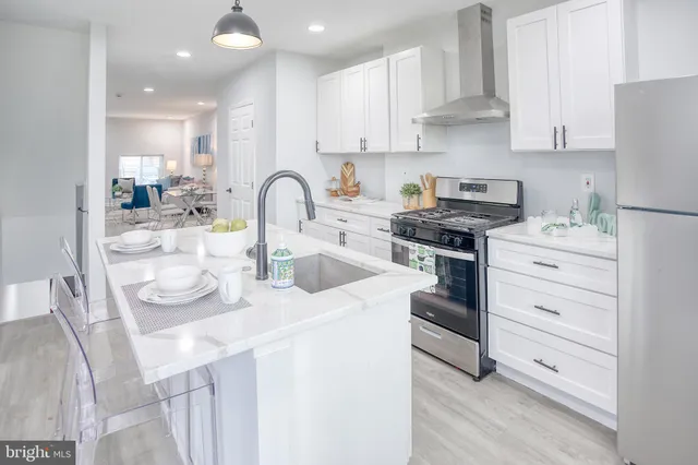 a kitchen with white cabinets and appliances