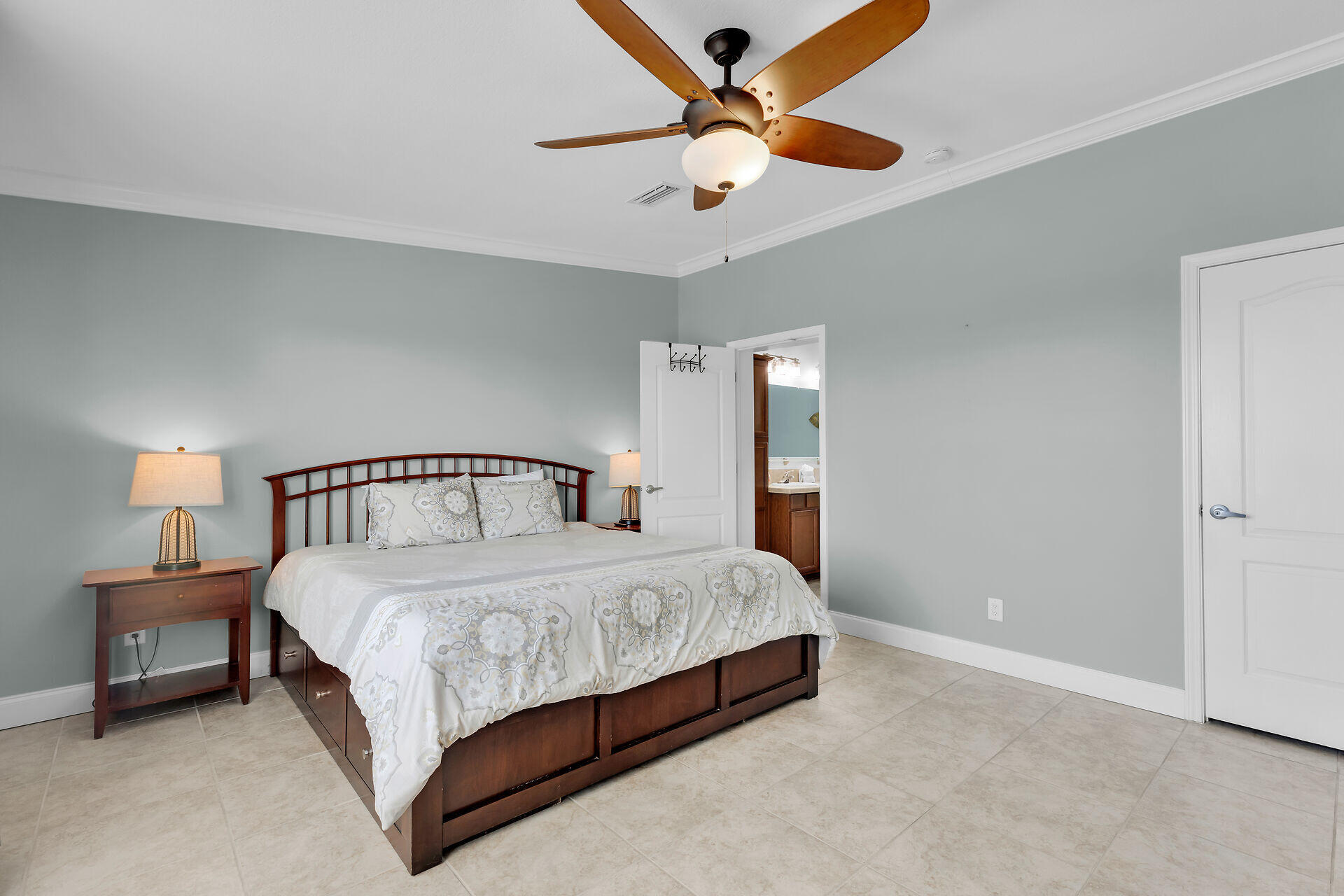 415 Sombrero Beach Road Marathon, FL 33050 - Photo 19 of 41 a bedroom with a bed and a chandelier