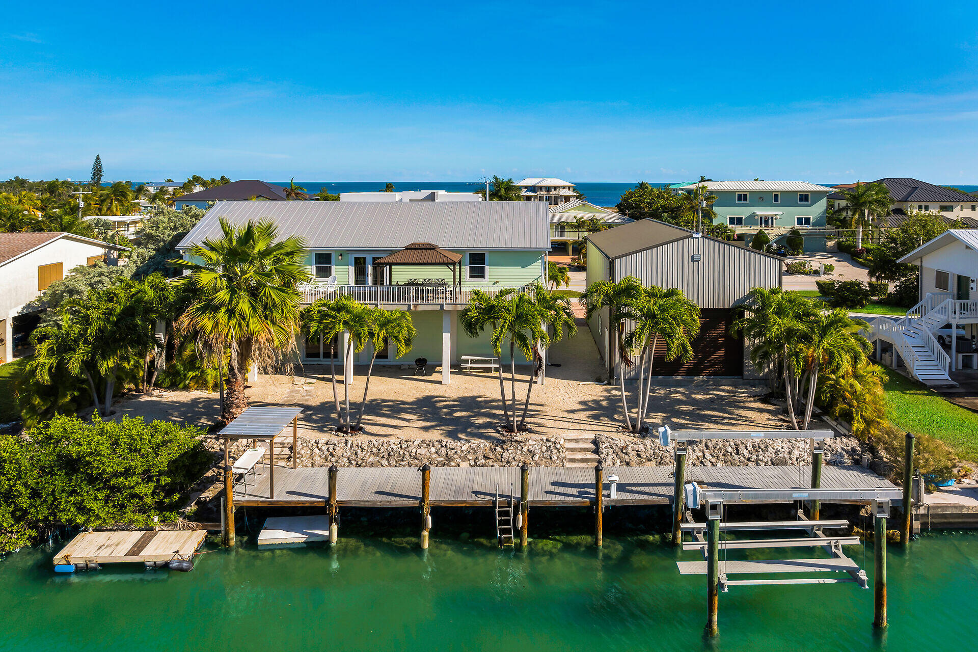 415 Sombrero Beach Road Marathon, FL 33050 - Photo 10 of 41 a view of a house with backyard porch and outdoor seating