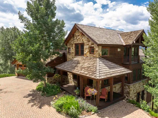 a view of house with roof deck and entertaining space