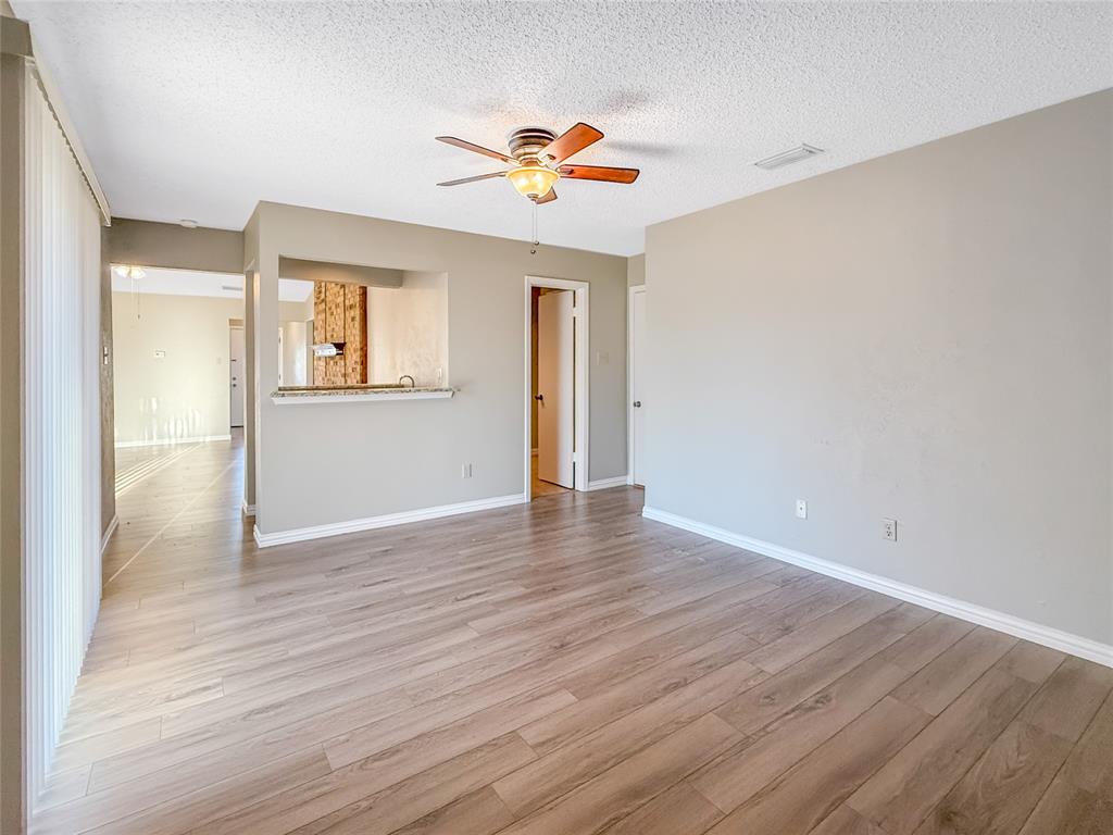 3614 Colbath Drive Garland, TX 75040 - Photo 11 of 24 a view of an empty room with wooden floor and a window