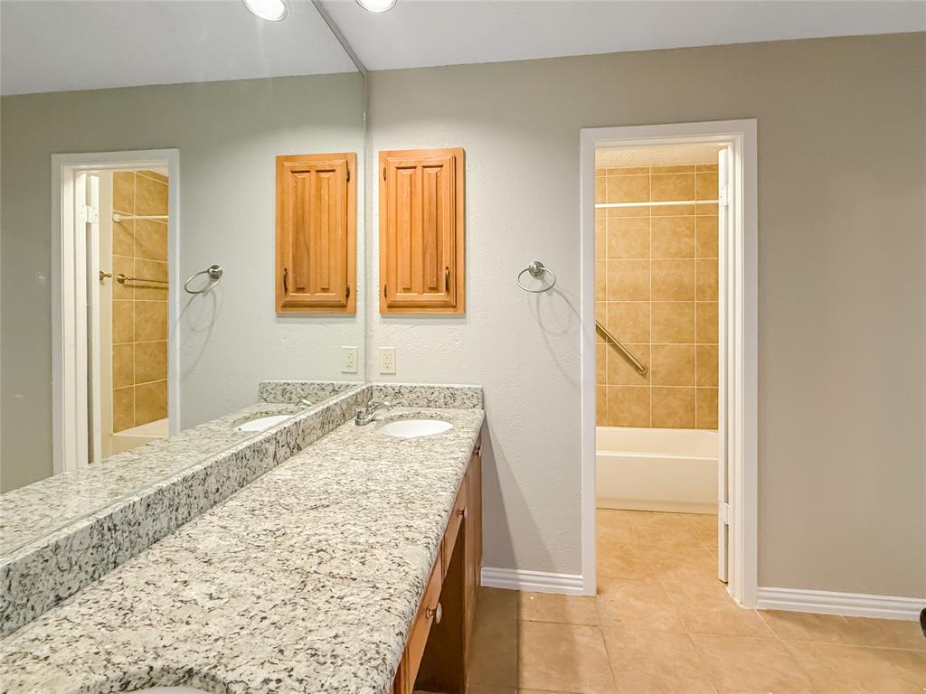 3614 Colbath Drive Garland, TX 75040 - Photo 15 of 24 a bathroom with a granite countertop sink and a bathtub