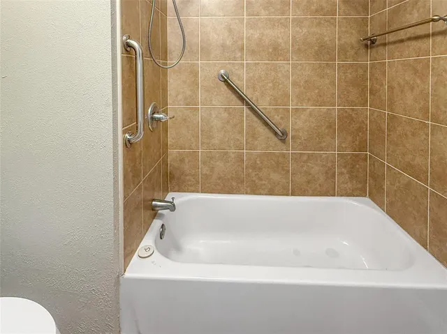 a white bath tub sitting next to a white toilet