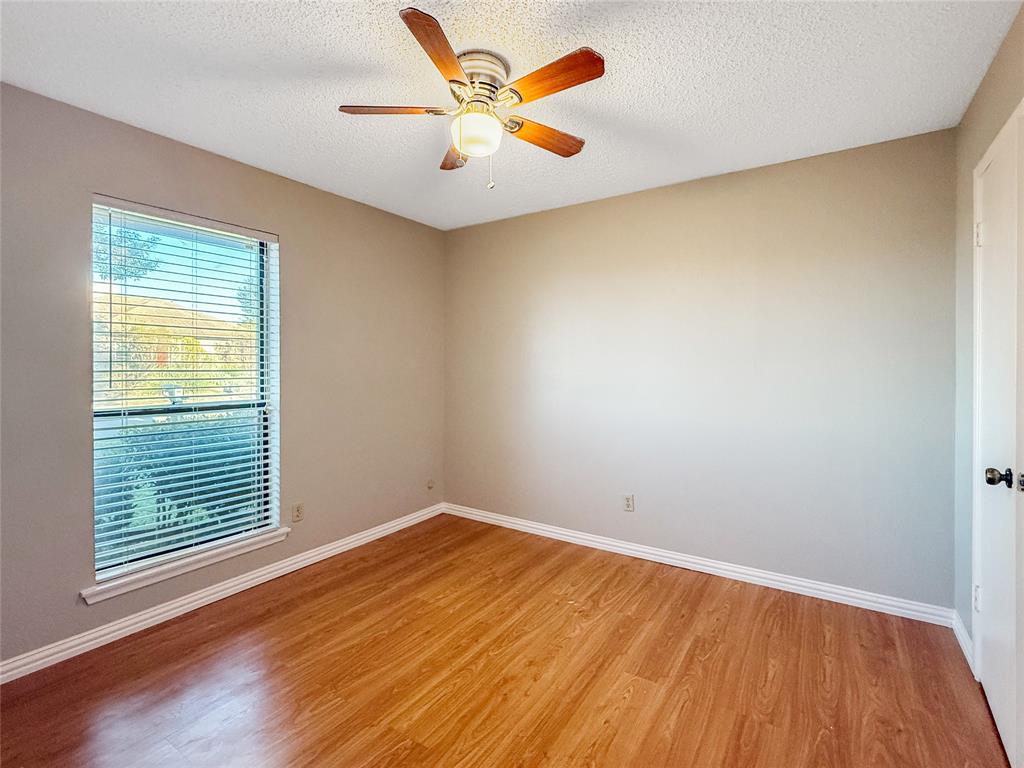 3614 Colbath Drive Garland, TX 75040 - Photo 18 of 24 an empty room with a window and a ceiling fan