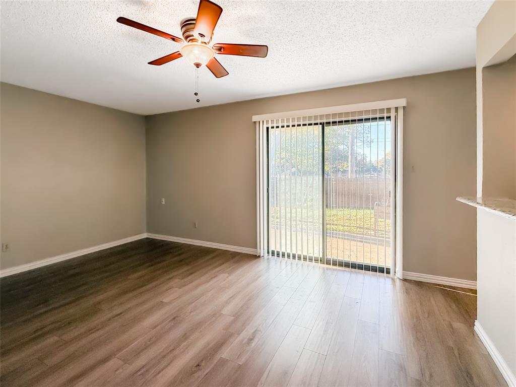 3614 Colbath Drive Garland, TX 75040 - Photo 9 of 24 an empty room with wooden floor and windows