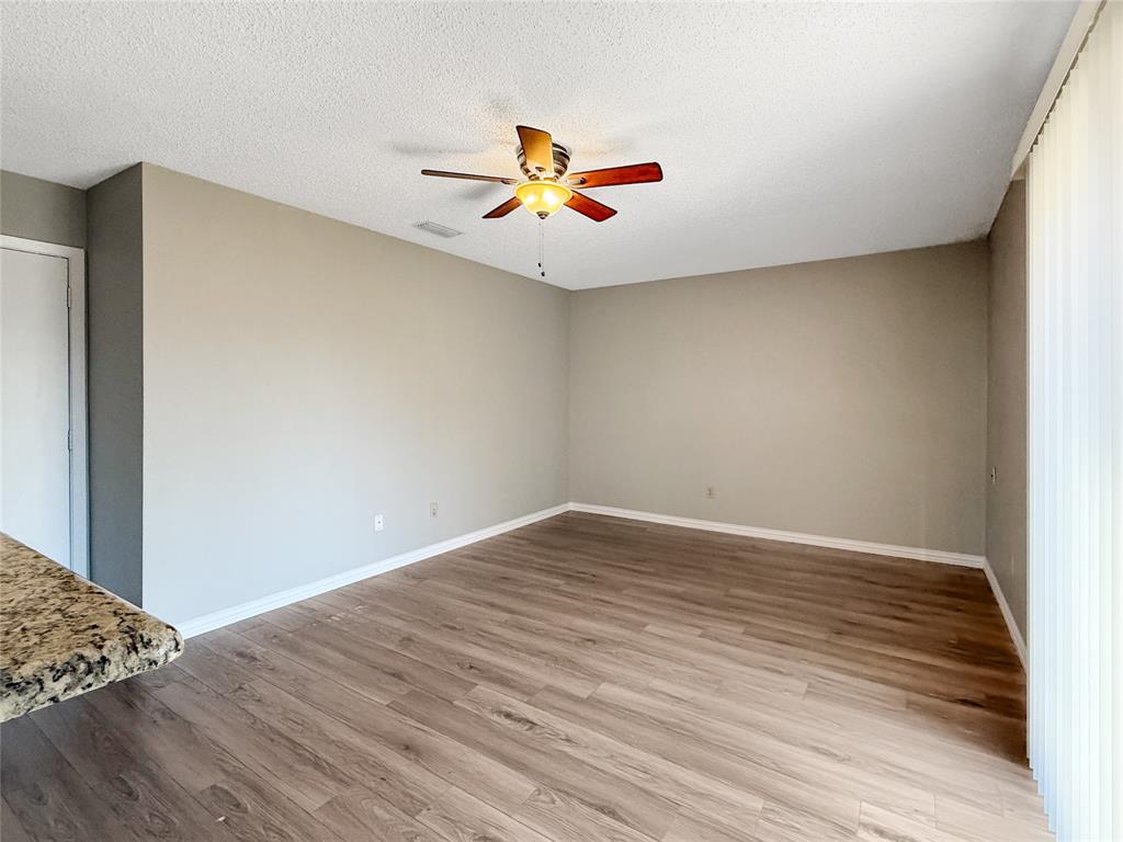 3614 Colbath Drive Garland, TX 75040 - Photo 10 of 24 wooden floor in an empty room with a window