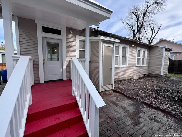 a view of a house with wooden floor and a yard
