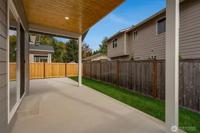 a view of a house with wooden fence